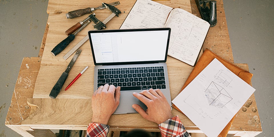 hands on laptop with tools